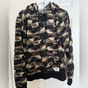 Conspiracy by WESC unisex camo hooded sweatshirt.